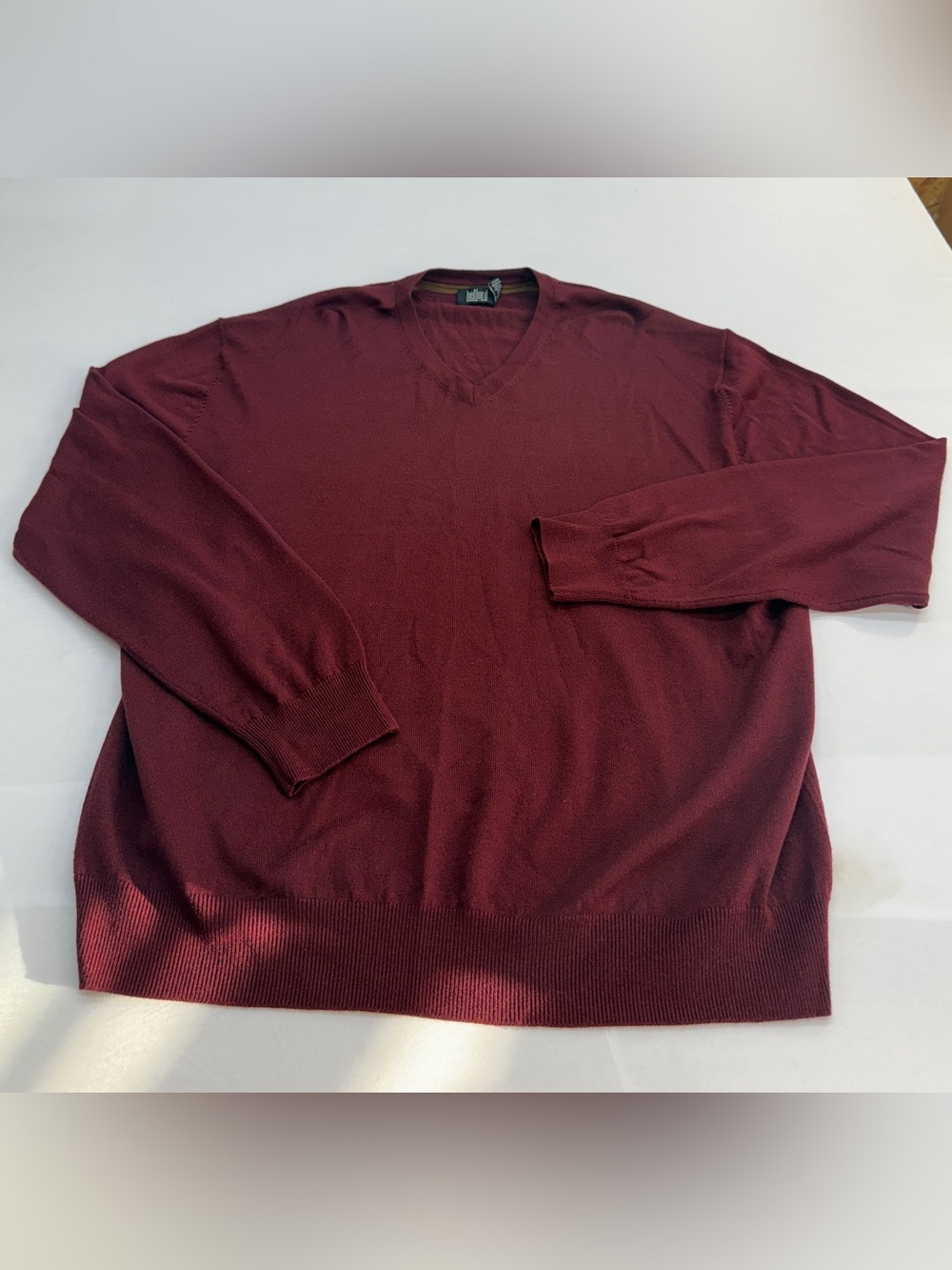 Men's V-Neck Sweater in Burgundy by Belford. Made of extra fine Merino Wool.